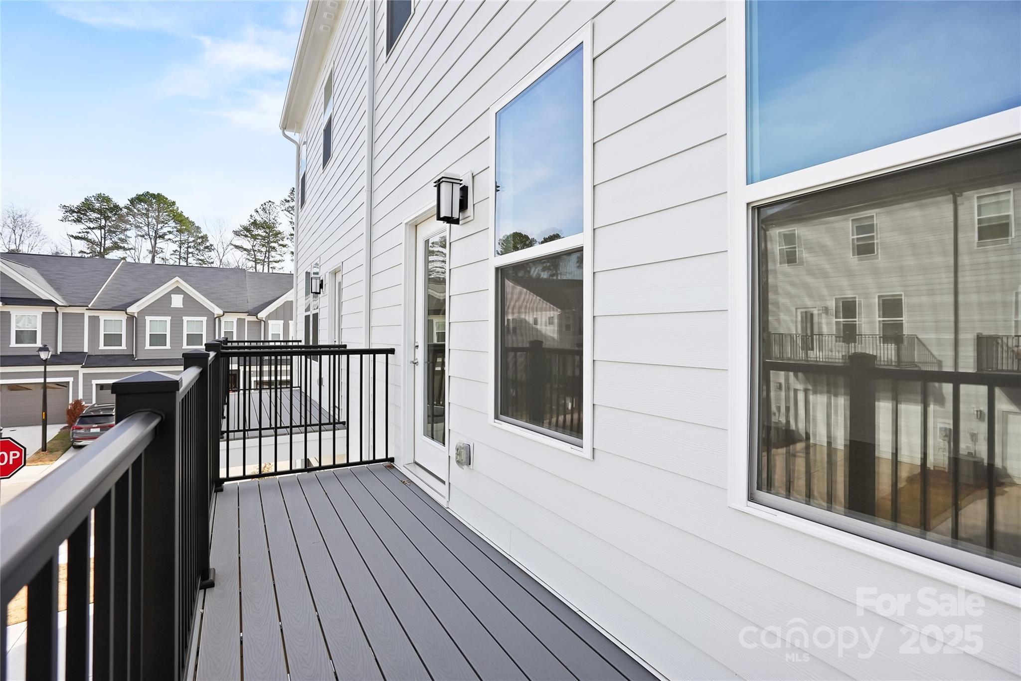 5007 Rill Court, Unit 35 Charlotte, NC 28262 - Photo 14 of 34 a view of a balcony with wooden floor and fence