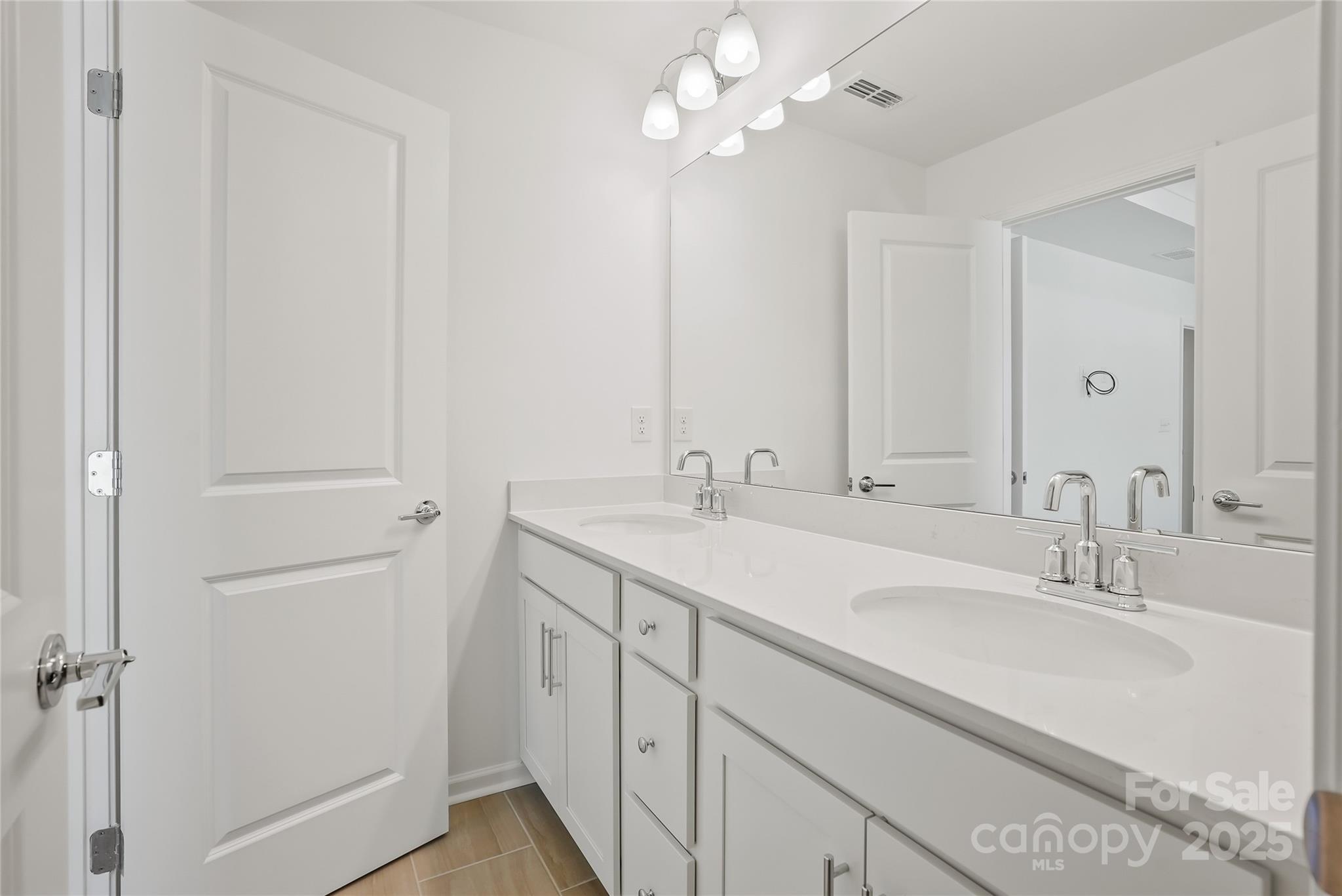 5007 Rill Court, Unit 35 Charlotte, NC 28262 - Photo 21 of 34 a bathroom with a sink vanity and a mirror