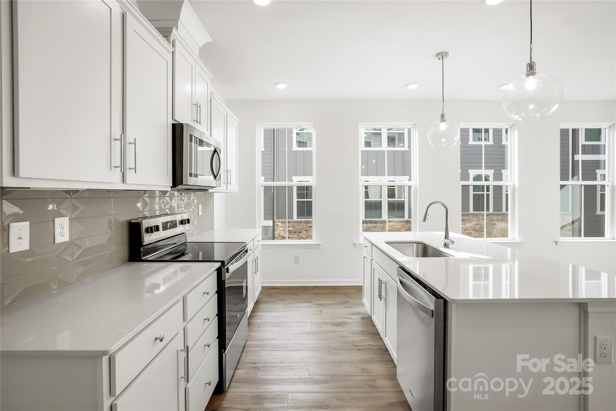 5007 Rill Court, Unit 35 Charlotte, NC 28262 - Photo 7 of 34 a kitchen with stainless steel appliances granite countertop a sink and stove