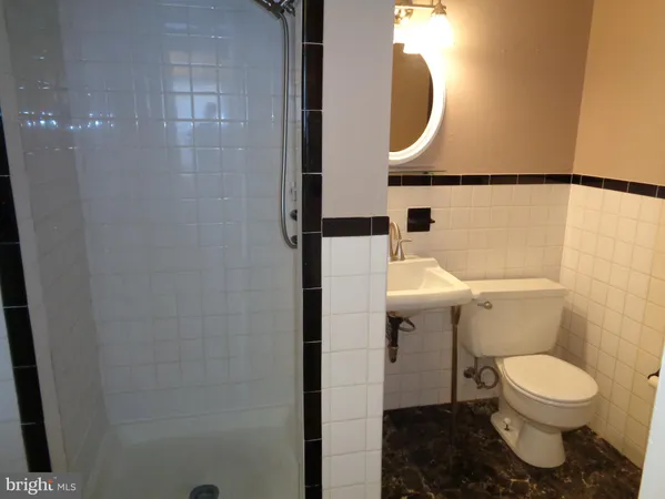 a bathroom with a toilet and a mirror