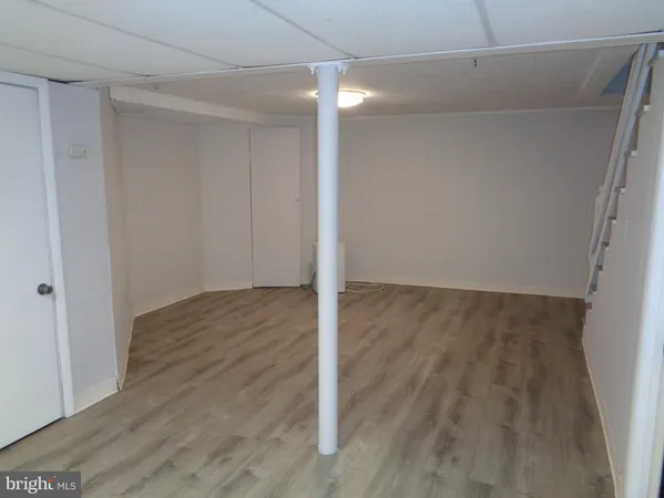 a view of a room with wooden floor and white walls