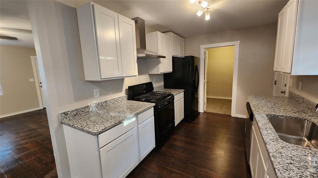 a kitchen with a sink stove and refrigerator