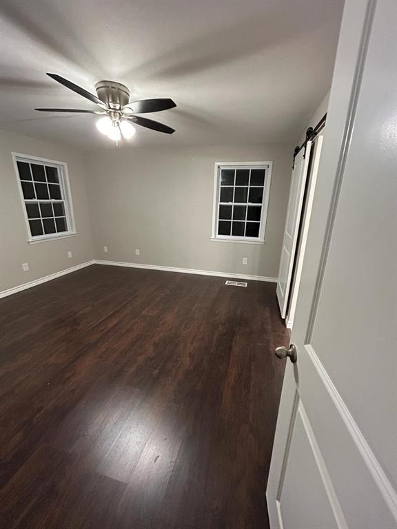 112 Elm Street Roxton, TX 75477 - Photo 14 of 21 wooden floor in an empty room with a window