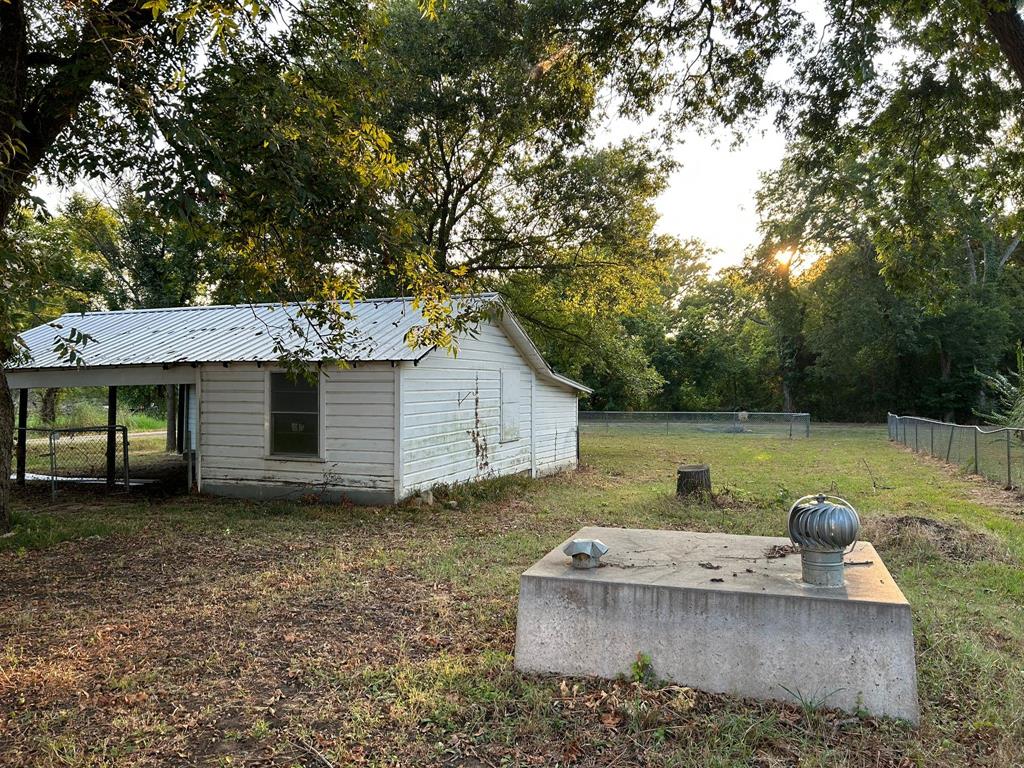 112 Elm Street Roxton, TX 75477 - Photo 20 of 21 a view of a house with a yard