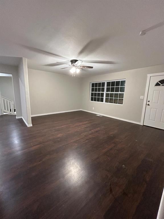 112 Elm Street Roxton, TX 75477 - Photo 2 of 21 an empty room with wooden floor and windows