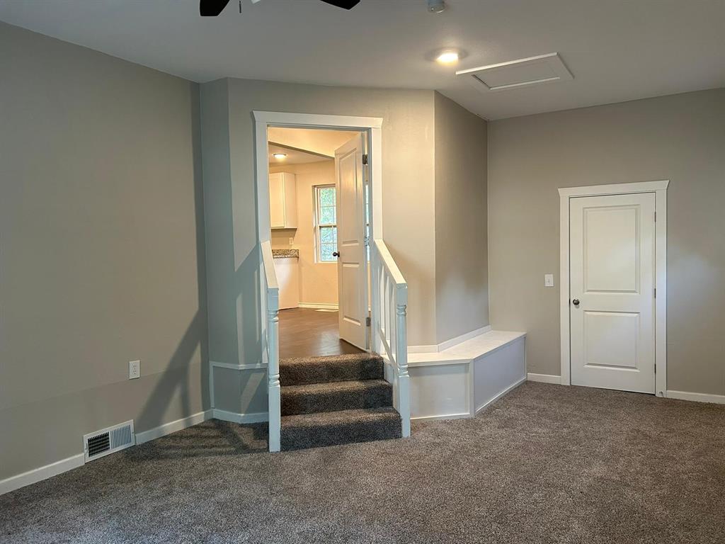 112 Elm Street Roxton, TX 75477 - Photo 7 of 21 a view of entryway with wooden floor and stairs
