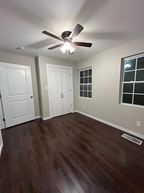 112 Elm Street Roxton, TX 75477 - Photo 9 of 21 a view of empty room with wooden floor and fan