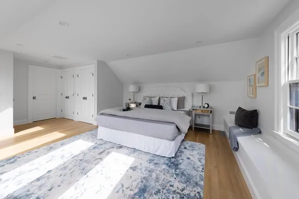 a bedroom with a bed and a view of living room