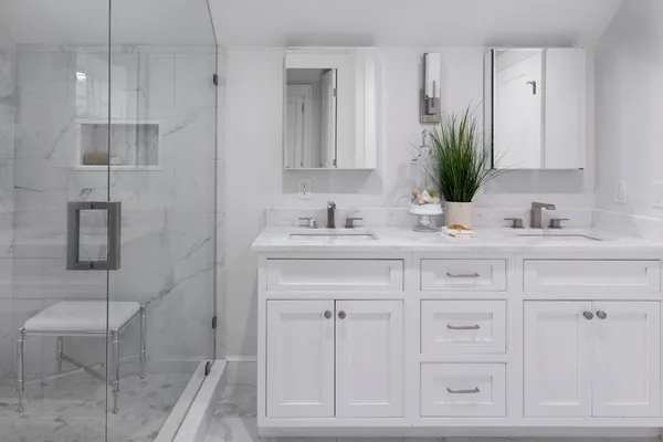 a bathroom with a sink vanity granite and a mirror