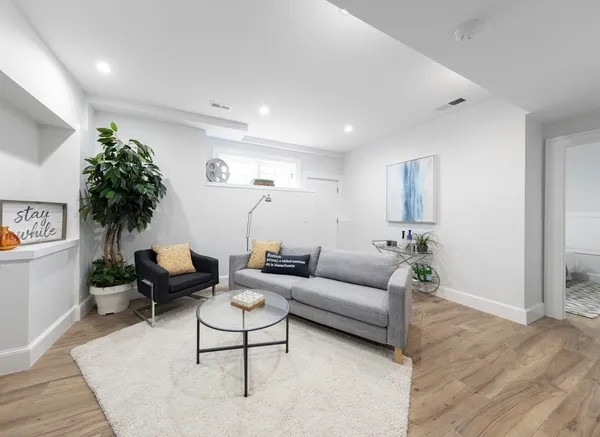 a living room with furniture and a potted plant