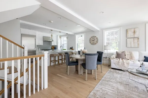 a living room with lots of furniture and kitchen view
