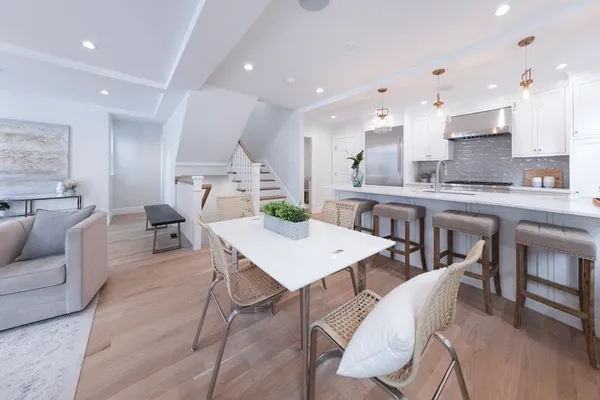 a large kitchen with a table and chairs