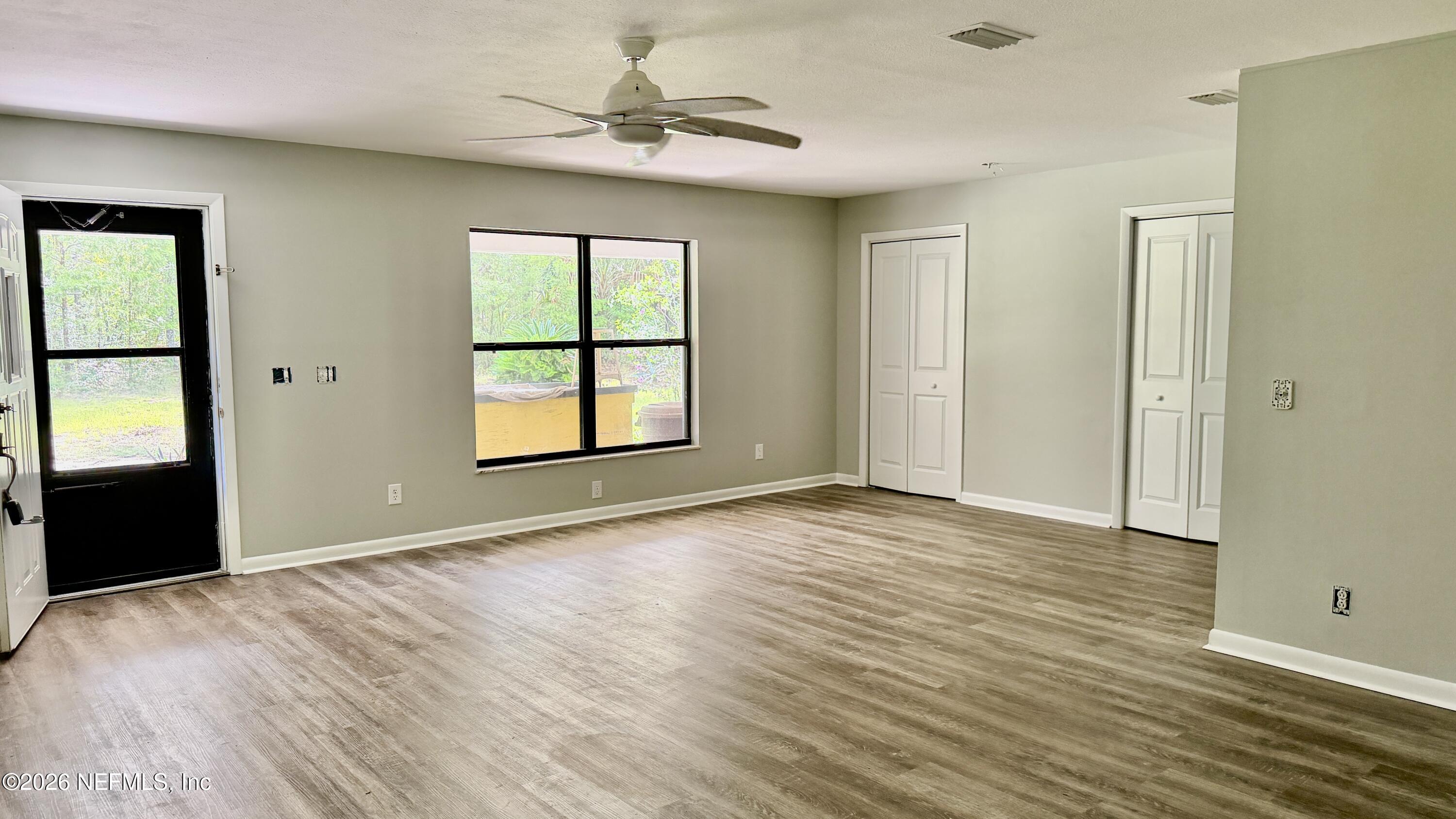 850 Cousintown Road Interlachen, FL 32148 - Photo 6 of 27 wooden floor in an empty room with a window