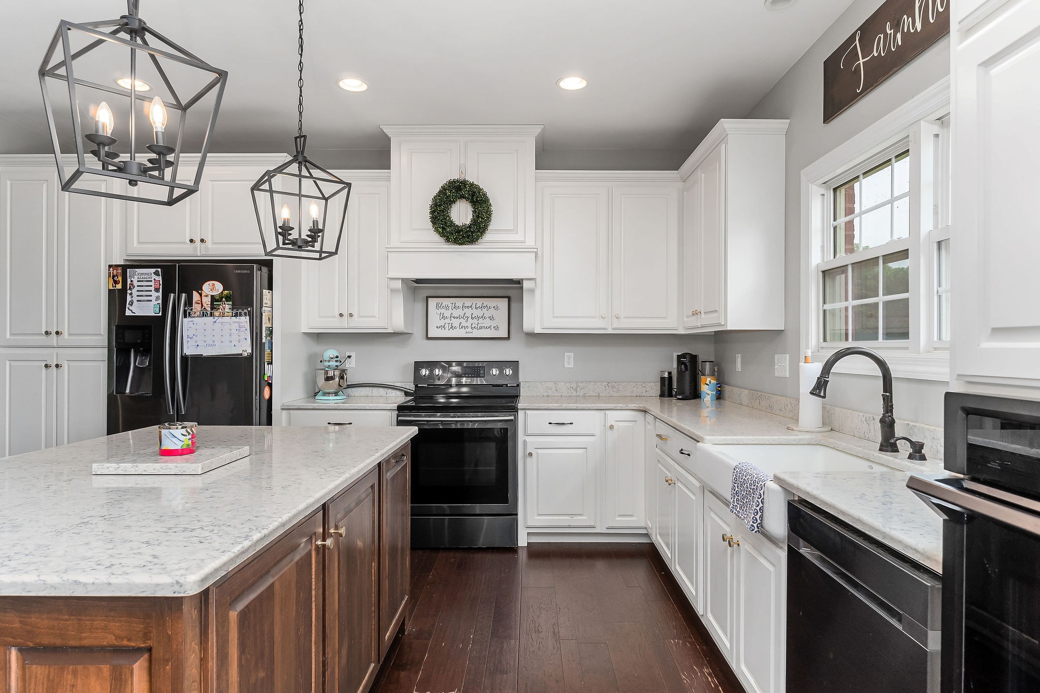 656 Osement Road McMinnville, TN 37110 - Photo 13 of 43 a kitchen with kitchen island granite countertop a stove a oven a refrigerator a sink dishwasher and white cabinets with wooden floor