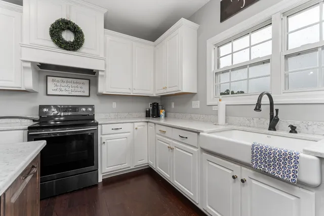 a kitchen with cabinets appliances and a window