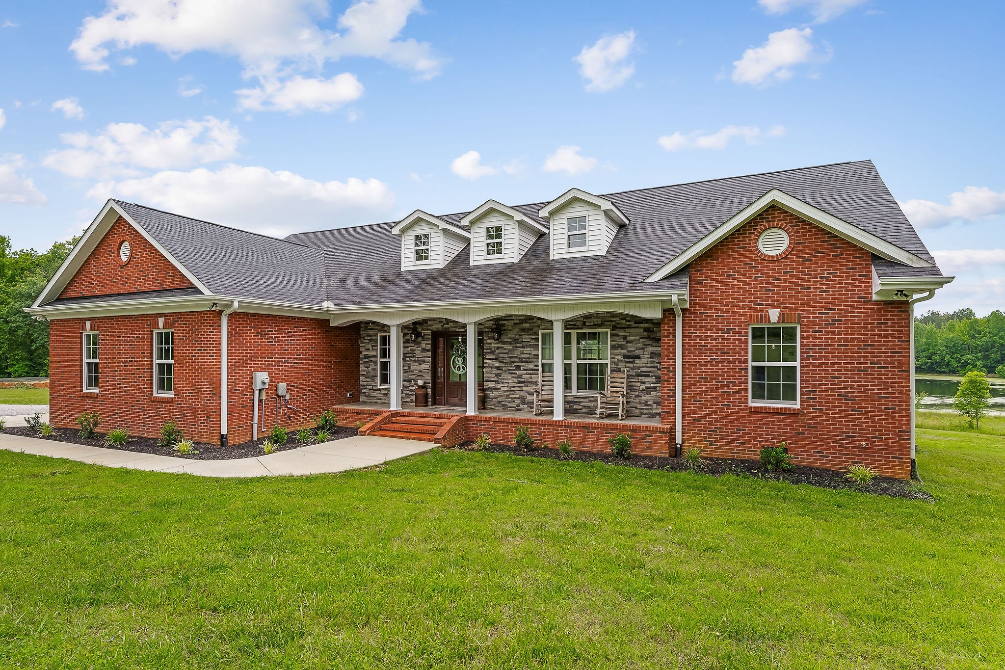 656 Osement Road McMinnville, TN 37110 - Photo 2 of 43 a front view of a house with a yard and garage