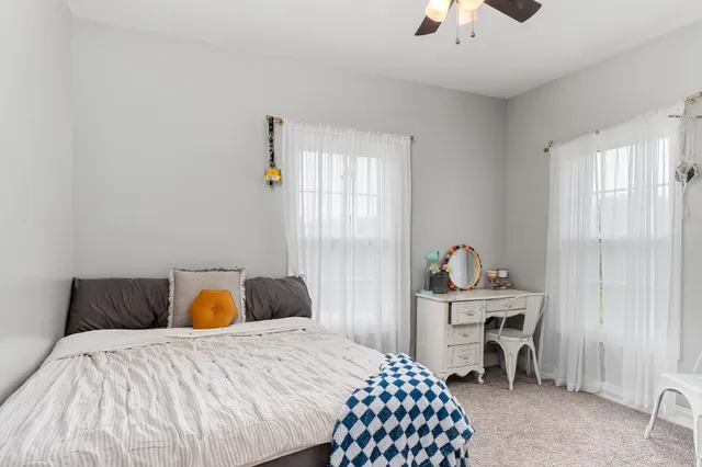 a bedroom with a bed and chair