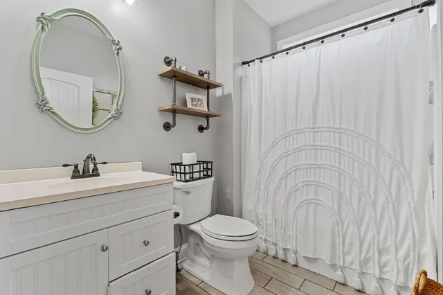 a bathroom with a toilet a sink and a mirror