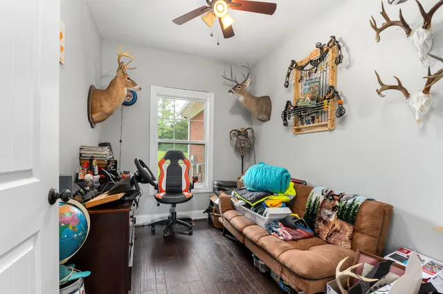a living room with furniture gym equipment and a window
