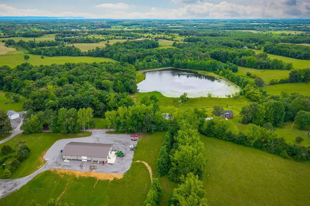 an aerial view of residential houses with outdoor space and river