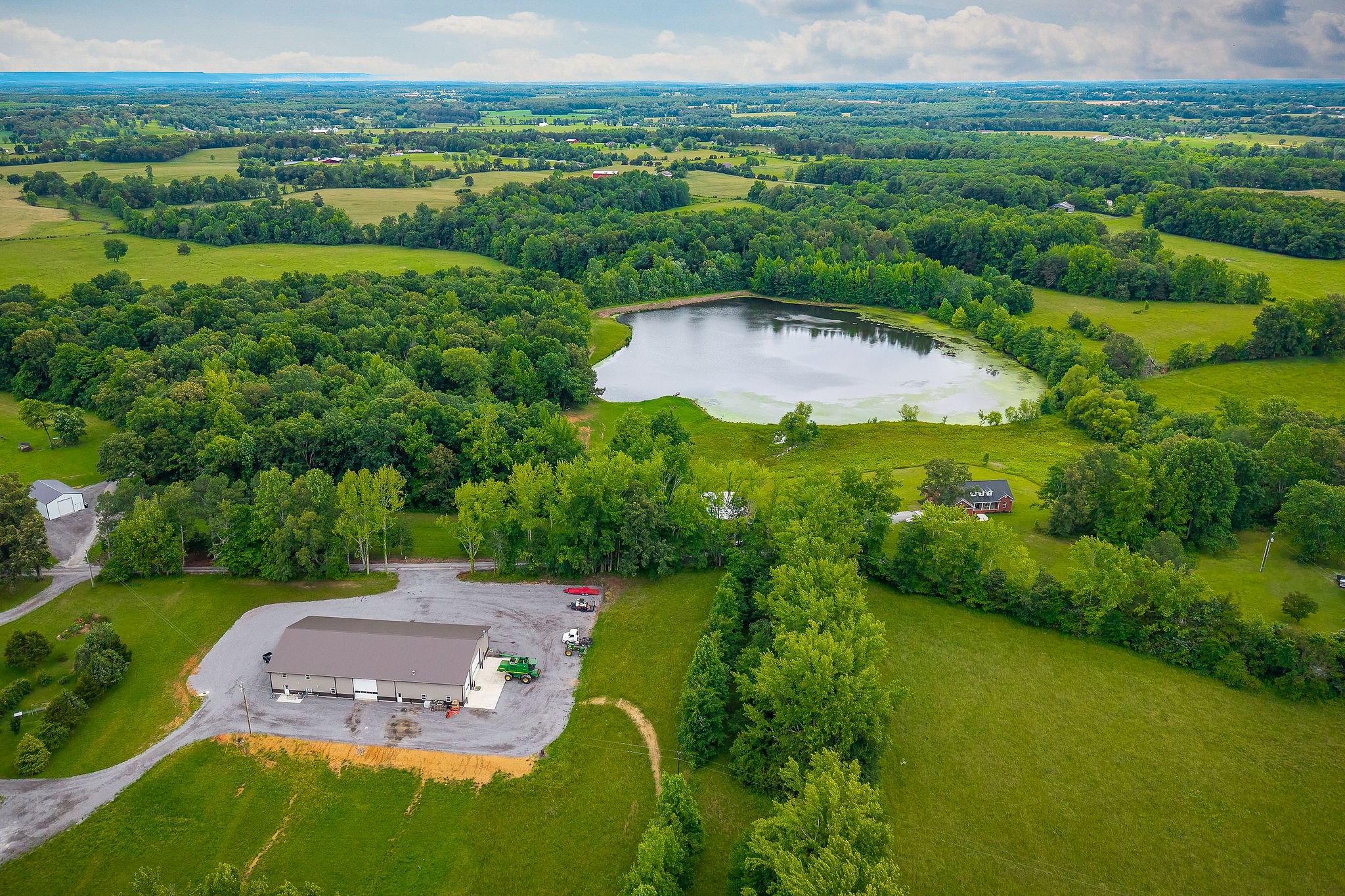 656 Osement Road McMinnville, TN 37110 - Photo 34 of 43 an aerial view of residential houses with outdoor space and river
