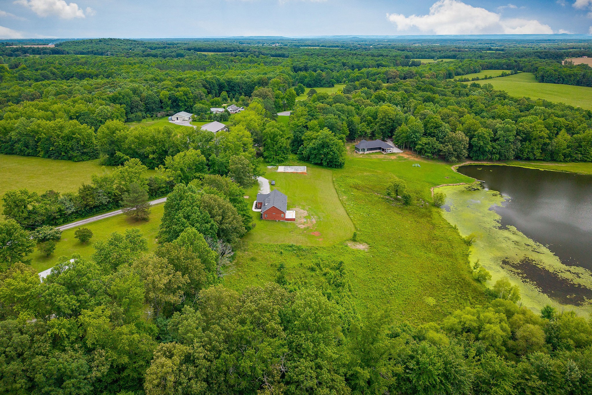 656 Osement Road McMinnville, TN 37110 - Photo 36 of 43 a view of a lake with a houses