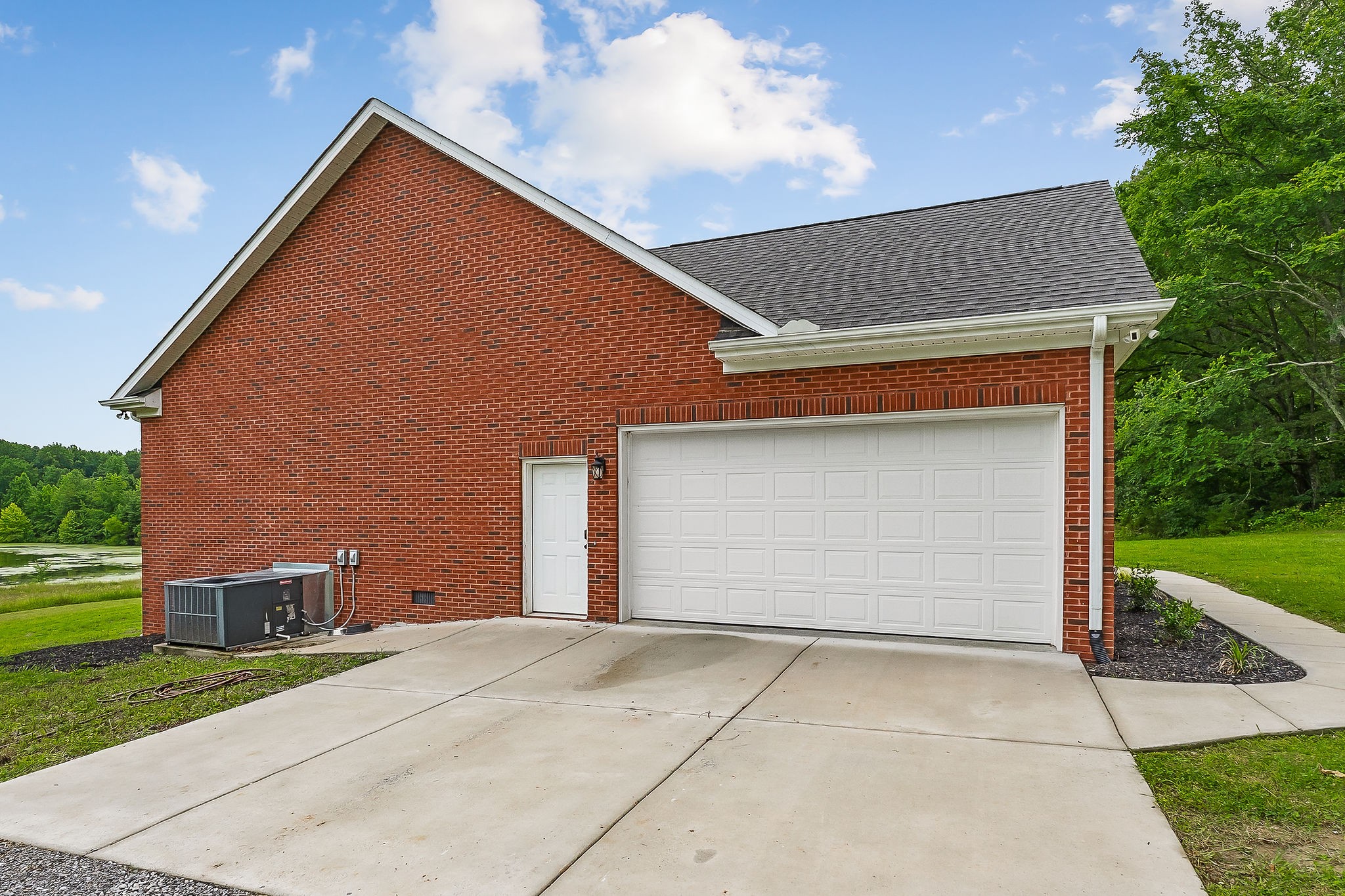 656 Osement Road McMinnville, TN 37110 - Photo 41 of 43 a front view of a house with a yard and garage