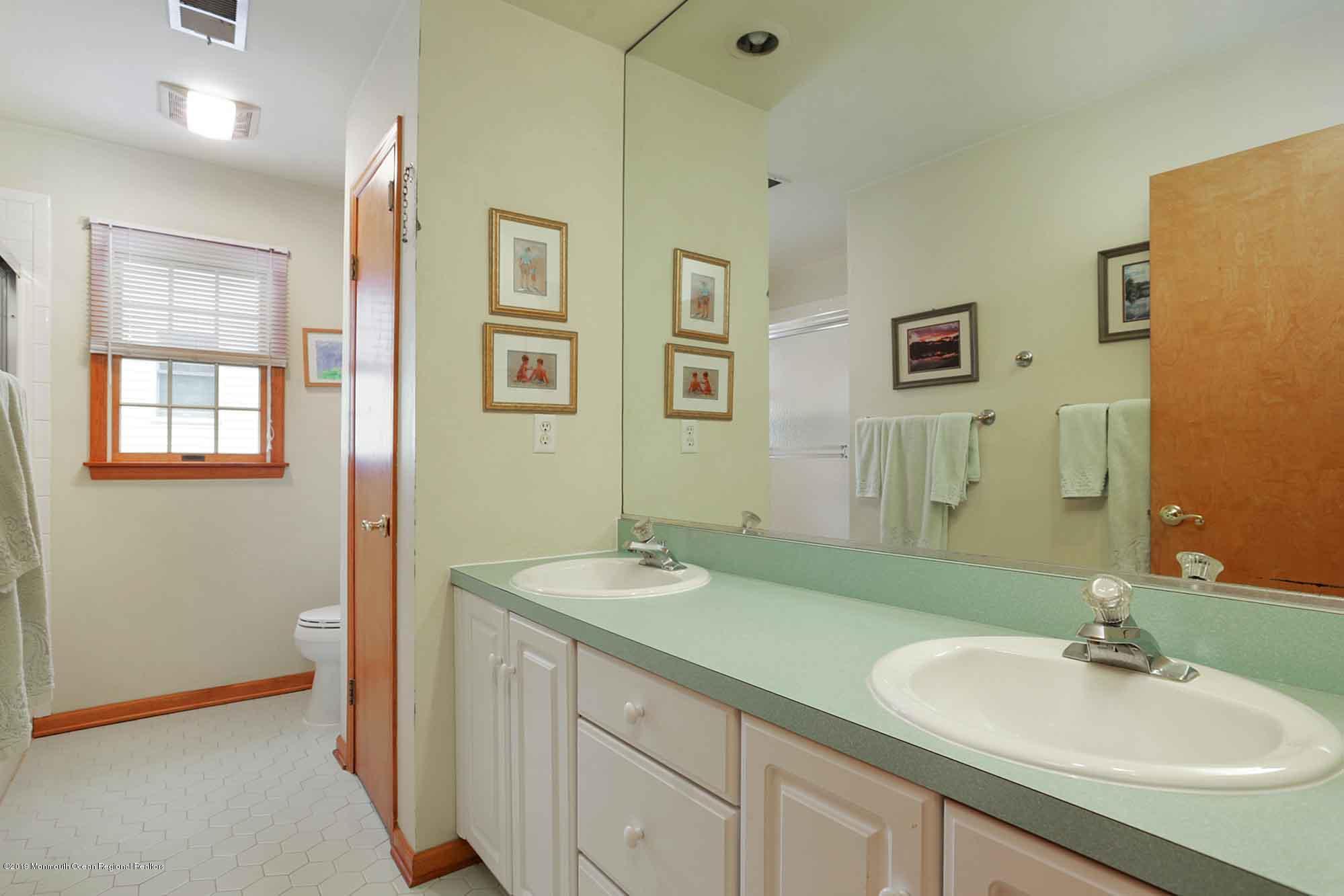 40 Ave Of Two Rivers Rumson, NJ 07760 - Photo 22 of 41 a bathroom with a sink and a mirror