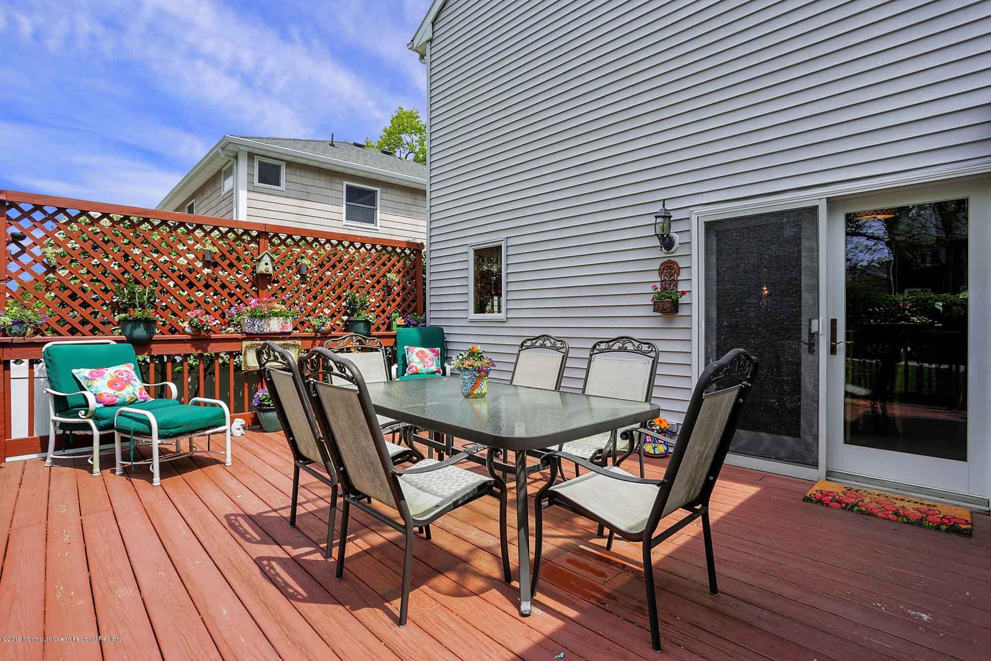 40 Ave Of Two Rivers Rumson, NJ 07760 - Photo 40 of 41 a deck with a table and chairs