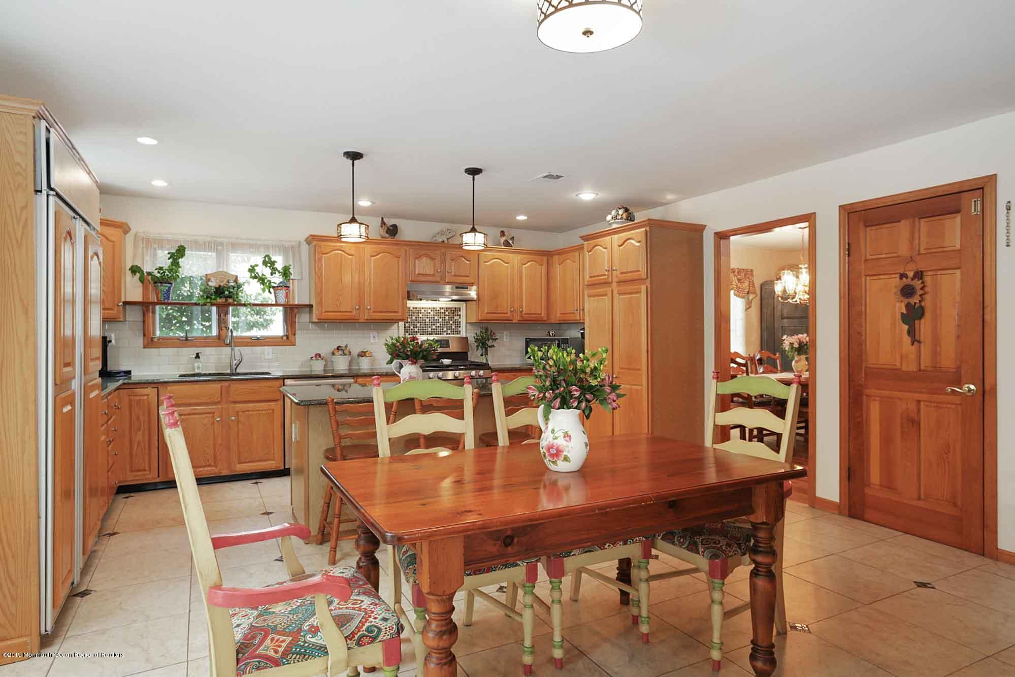 40 Ave Of Two Rivers Rumson, NJ 07760 - Photo 8 of 41 a dining room with a table chairs and kitchen view