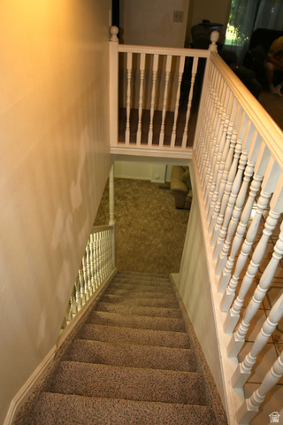 1612 East 450 South Springville, UT 84663 - Photo 32 of 48 Carpeted staircase with white painted wood balusters and newel posts