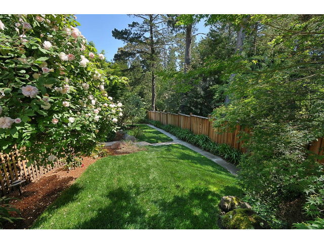 255 Darrell Road Hillsborough, CA 94010 - Photo 22 of 25 a view of a yard with plants and wooden fence