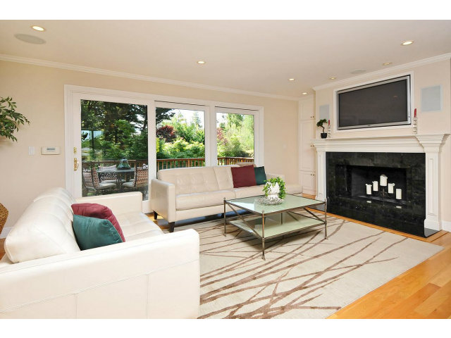 255 Darrell Road Hillsborough, CA 94010 - Photo 10 of 25 a living room with furniture a large window and a fireplace
