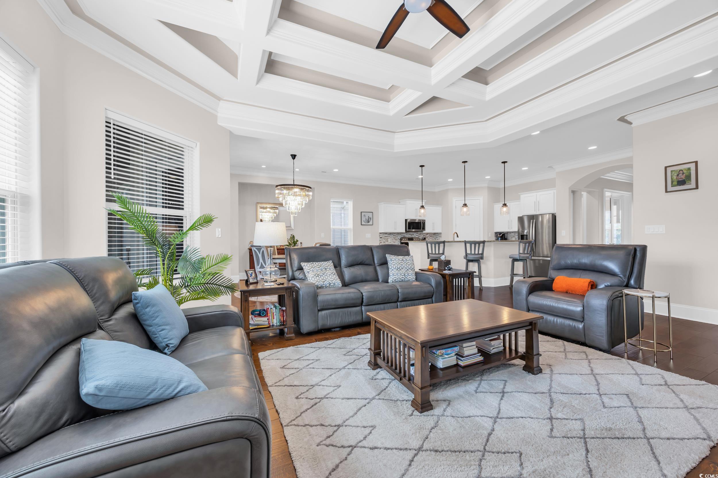 937 Bluffview Drive Myrtle Beach, SC 29579 - Photo 19 of 40 Living room with coffered ceiling, beam ceiling, ornamental molding, wood finished floors, and a ceiling fan