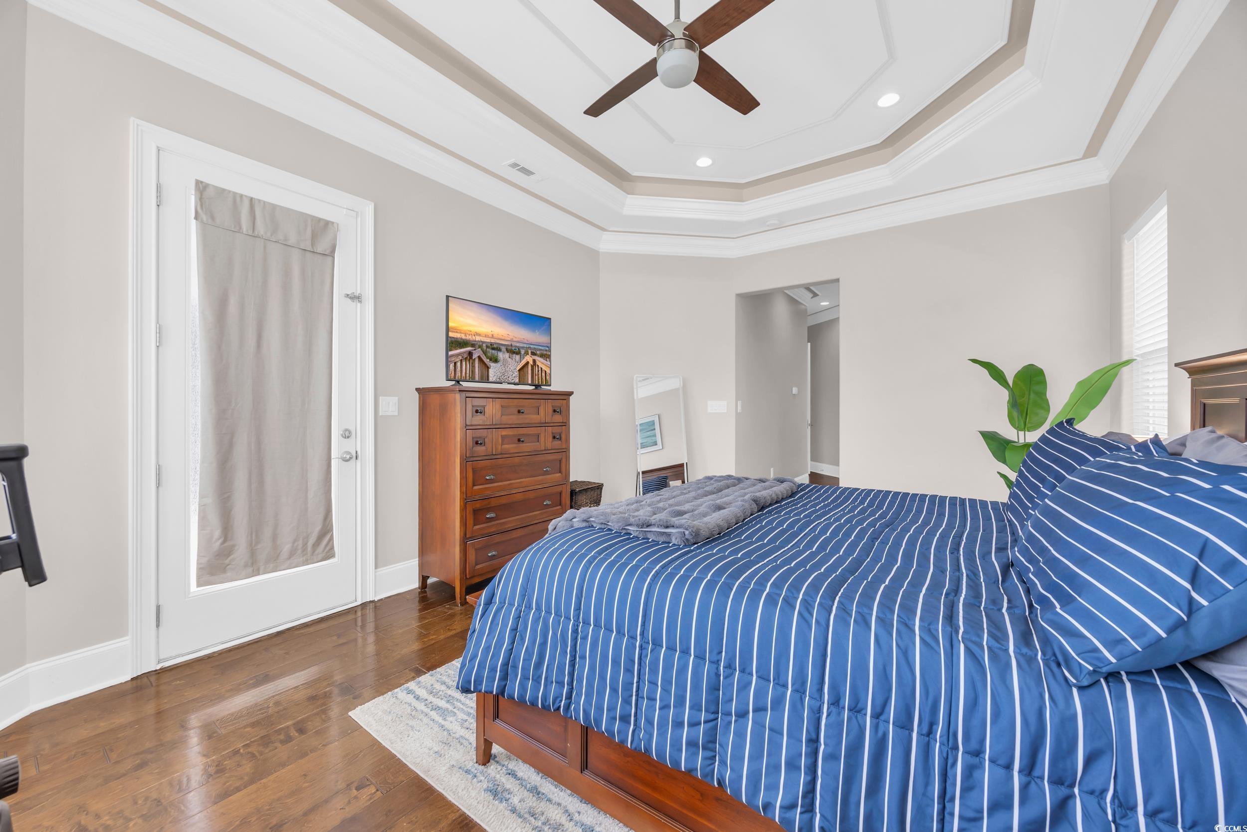 937 Bluffview Drive Myrtle Beach, SC 29579 - Photo 26 of 40 Bedroom with a raised ceiling, dark wood finished floors, ornamental molding, recessed lighting, and a ceiling fan