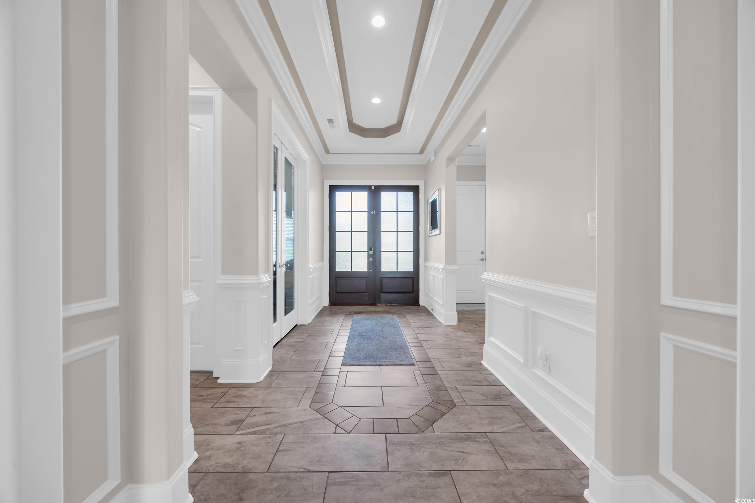 937 Bluffview Drive Myrtle Beach, SC 29579 - Photo 39 of 40 Entryway with french doors, light tile patterned flooring, a decorative wall, a tray ceiling, and crown molding