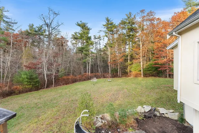 a backyard of a house with table and chairs