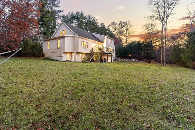 a front view of a house with a yard and trees