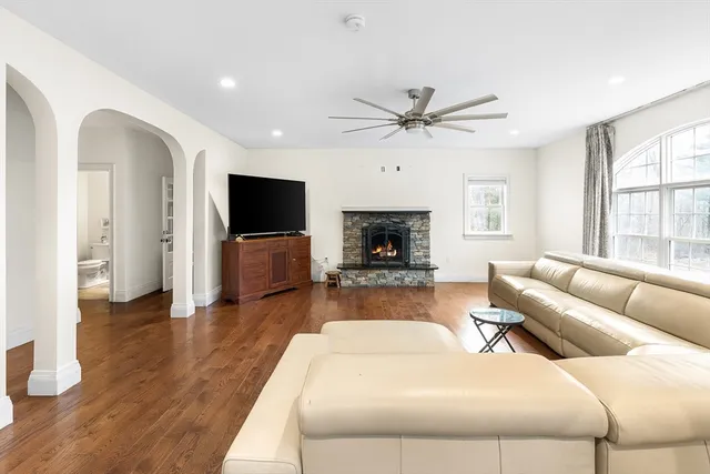 a living room with furniture flat screen tv and wooden floor