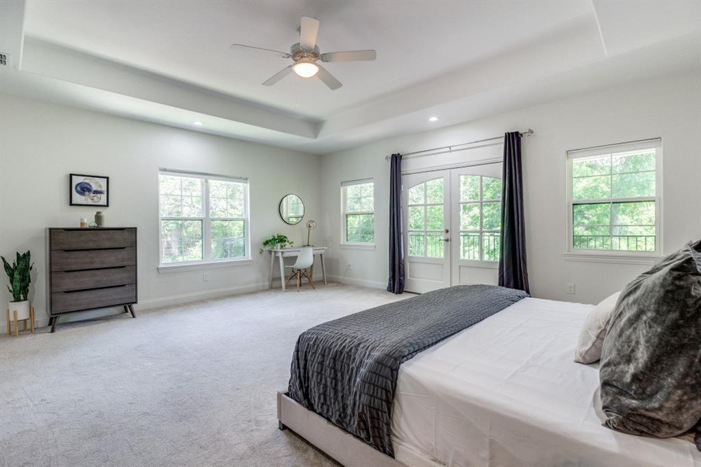 1000 Cameron Avenue Dallas, TX 75223 - Photo 18 of 38 a spacious bedroom with a bed a dresser and a window