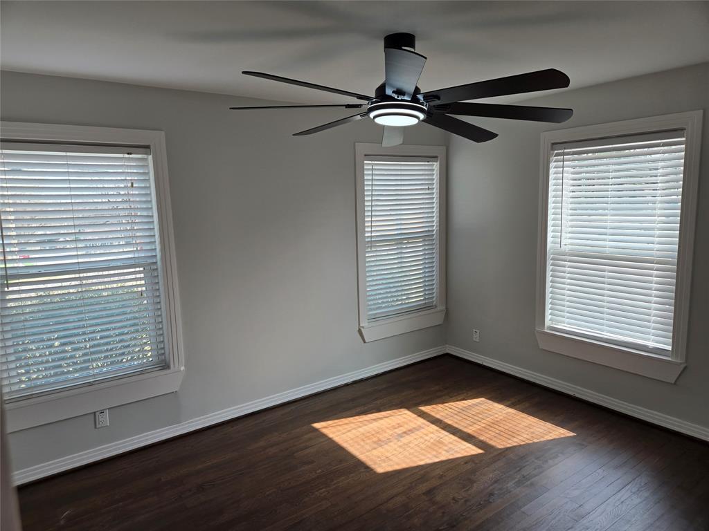 404 South Pecan Street Bells, TX 75414 - Photo 11 of 20 a view of empty room with wooden floor and fan