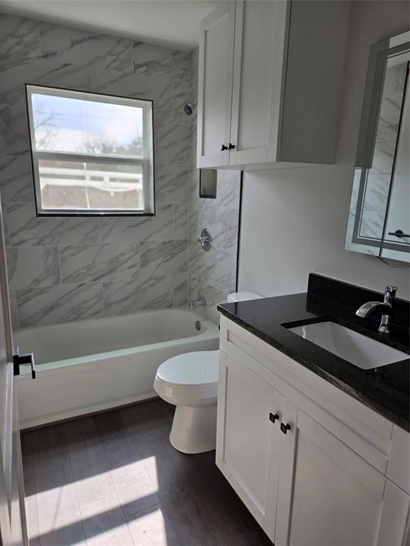 404 South Pecan Street Bells, TX 75414 - Photo 12 of 20 a bathroom with a granite countertop toilet a sink and bathtub