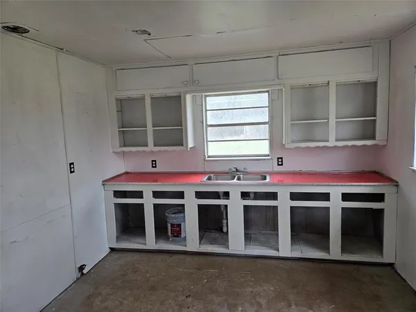 a view of a kitchen with stainless steel appliances wooden cabinets and a stove top oven