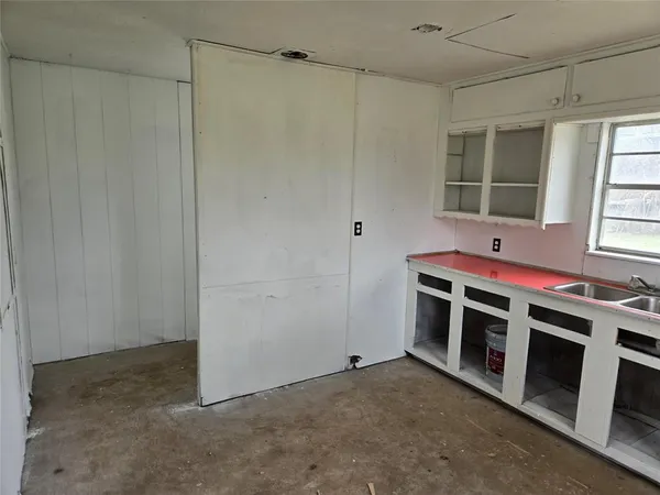 a view of a livingroom with an empty space and a window
