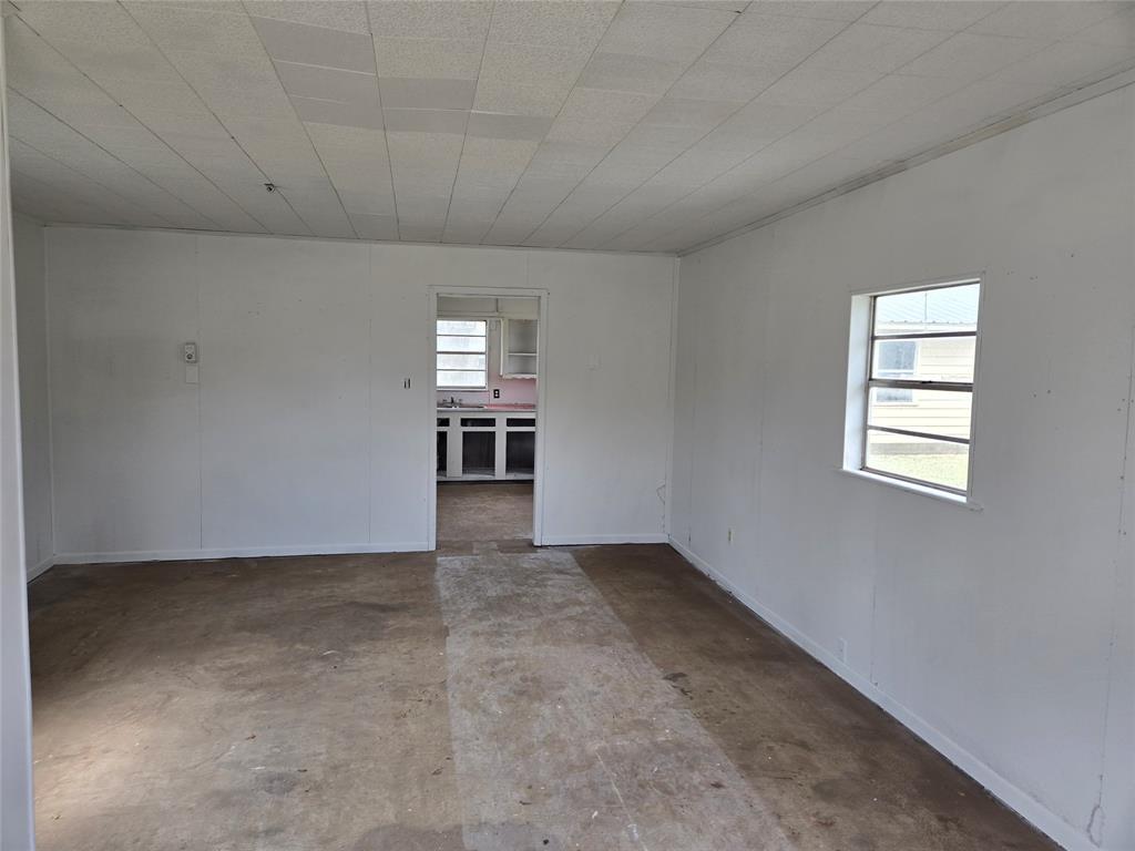 404 South Pecan Street Bells, TX 75414 - Photo 18 of 20 an empty room with chandelier fan and windows