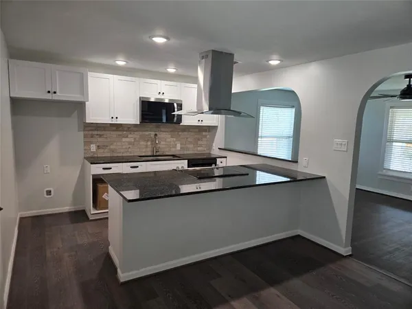 a kitchen with stainless steel appliances granite countertop a sink and a stove