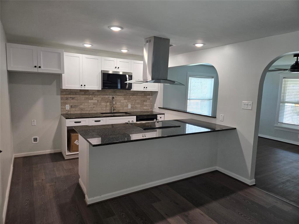 404 South Pecan Street Bells, TX 75414 - Photo 6 of 20 a kitchen with stainless steel appliances granite countertop a sink and a stove