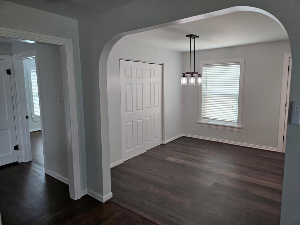404 South Pecan Street Bells, TX 75414 - Photo 8 of 20 an empty room with wooden floor windows and cabinet