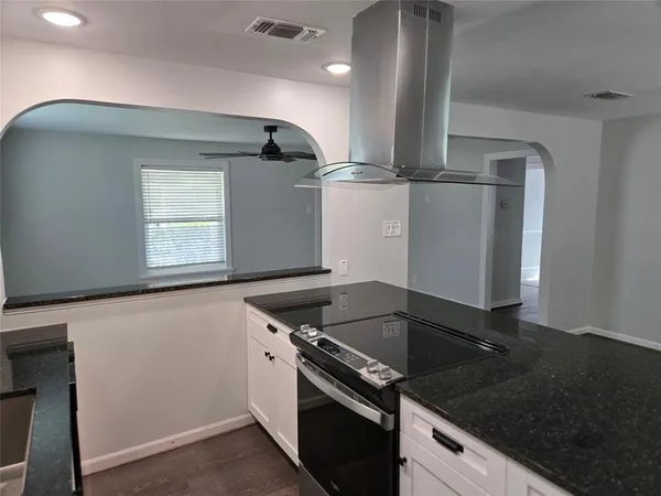 a kitchen with granite countertop a stove and a sink