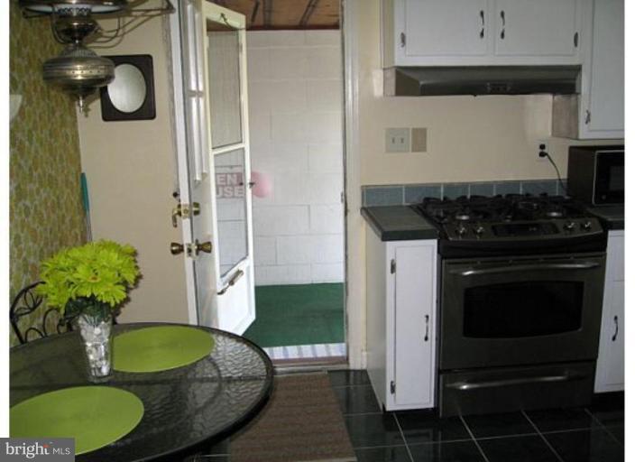 9117 Smith Avenue Nottingham, MD 21236 - Photo 12 of 17 a kitchen with a sink stove and refrigerator
